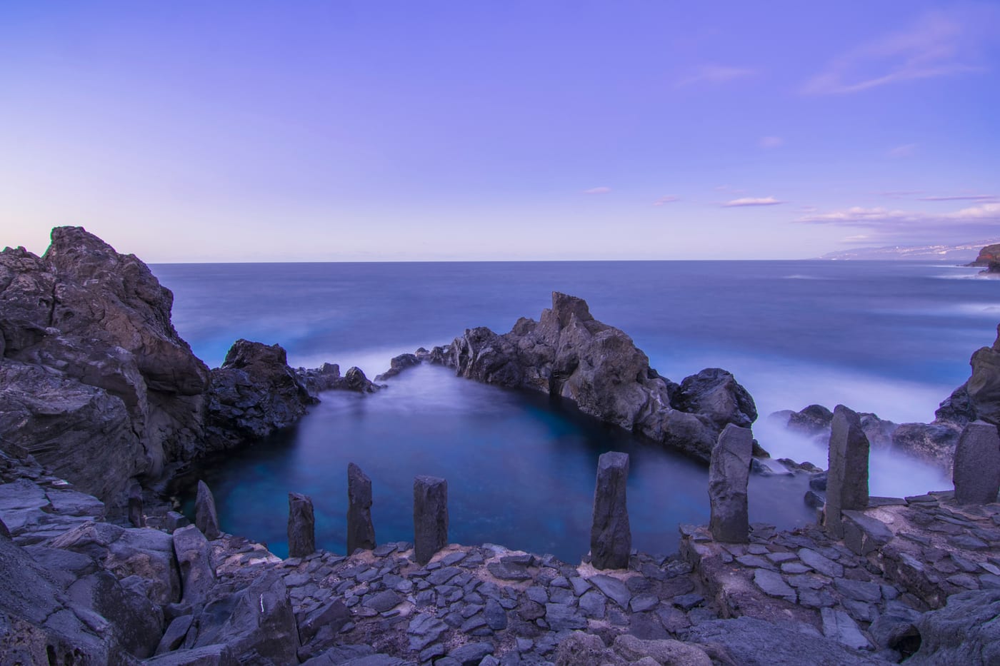 Charco de la Laja al atardecer, piscina natural de roca volcánica frente al océano en San Juan de la Rambla, costa norte de Tenerife.